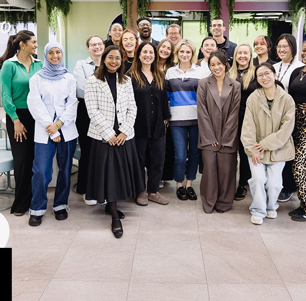 Image of a diverse group smiling together, in a community gathering