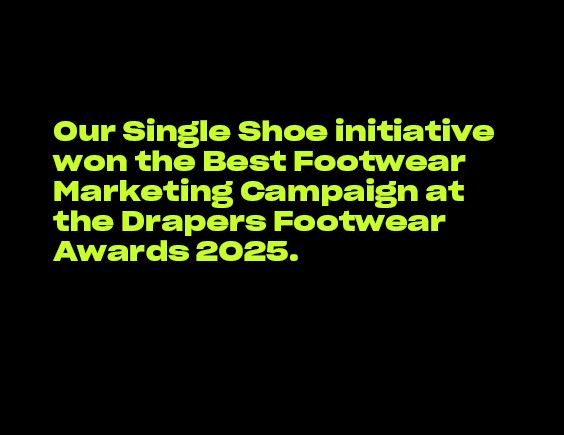 Image with black background and green text about Schuh’s Single Shoe campaign winning a Drapers award.