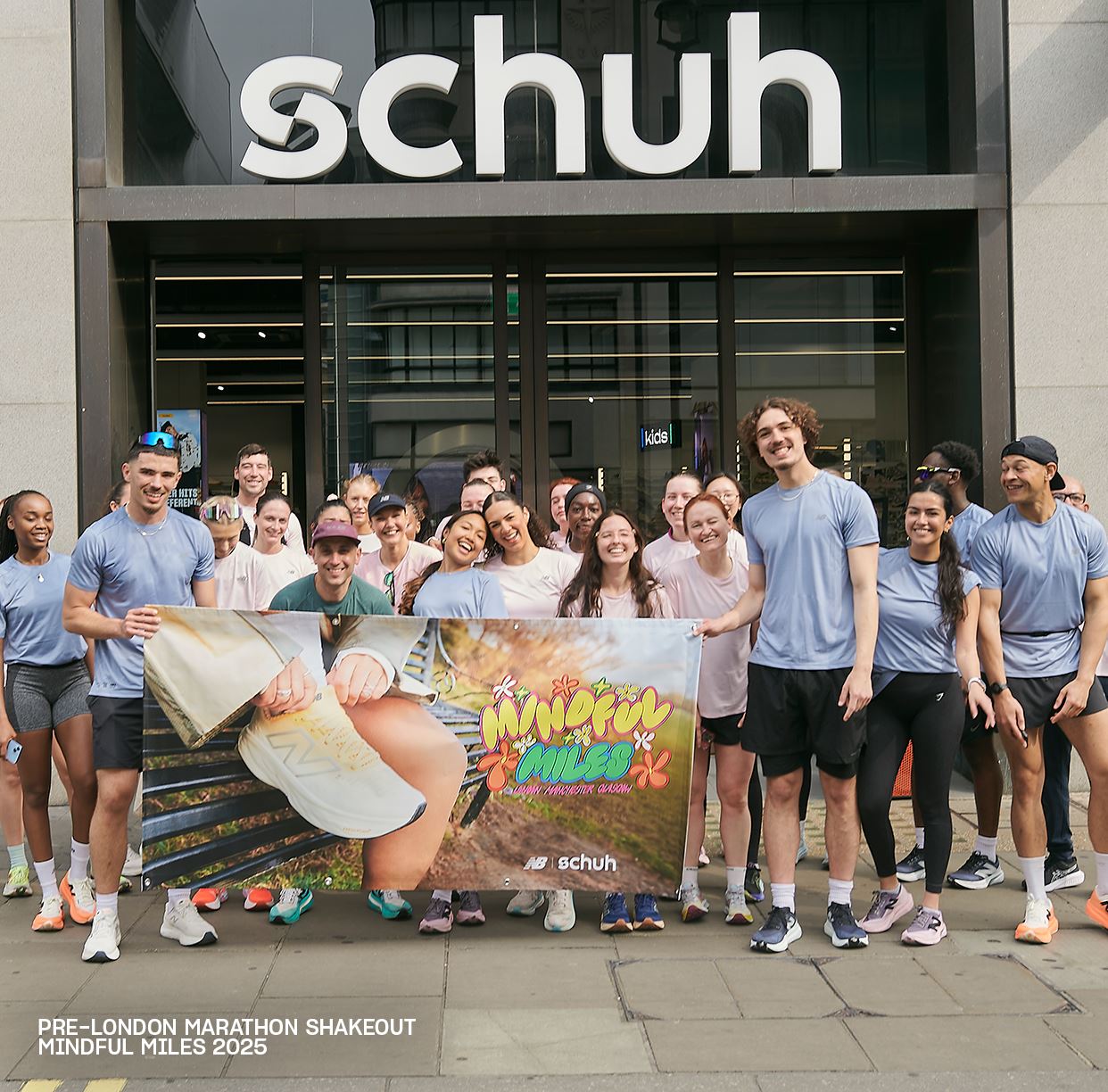 Image of a group posing outside a Schuh store, holding a “Mindful Miles” banner for London Marathon 2025.