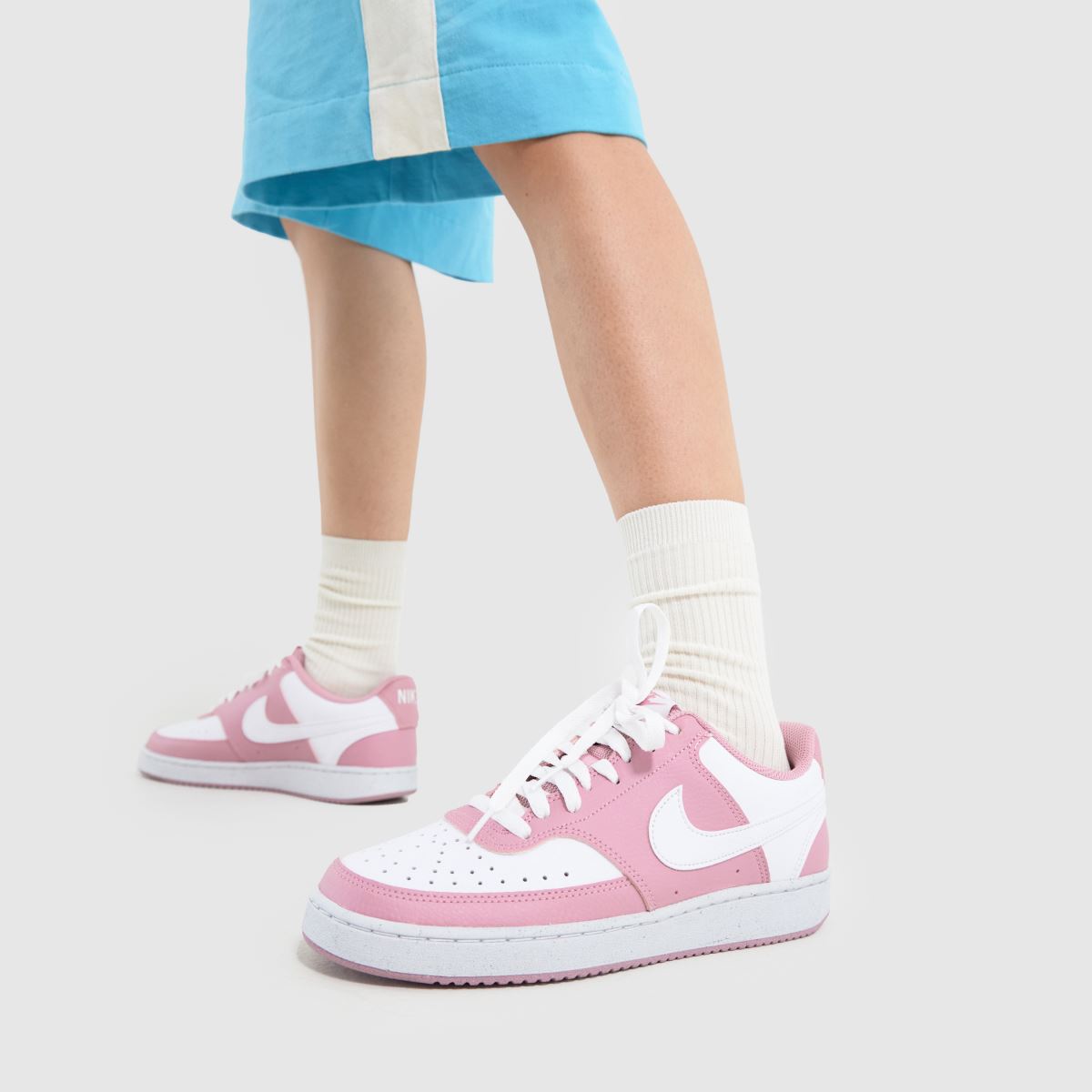 white and pink court vision trainers