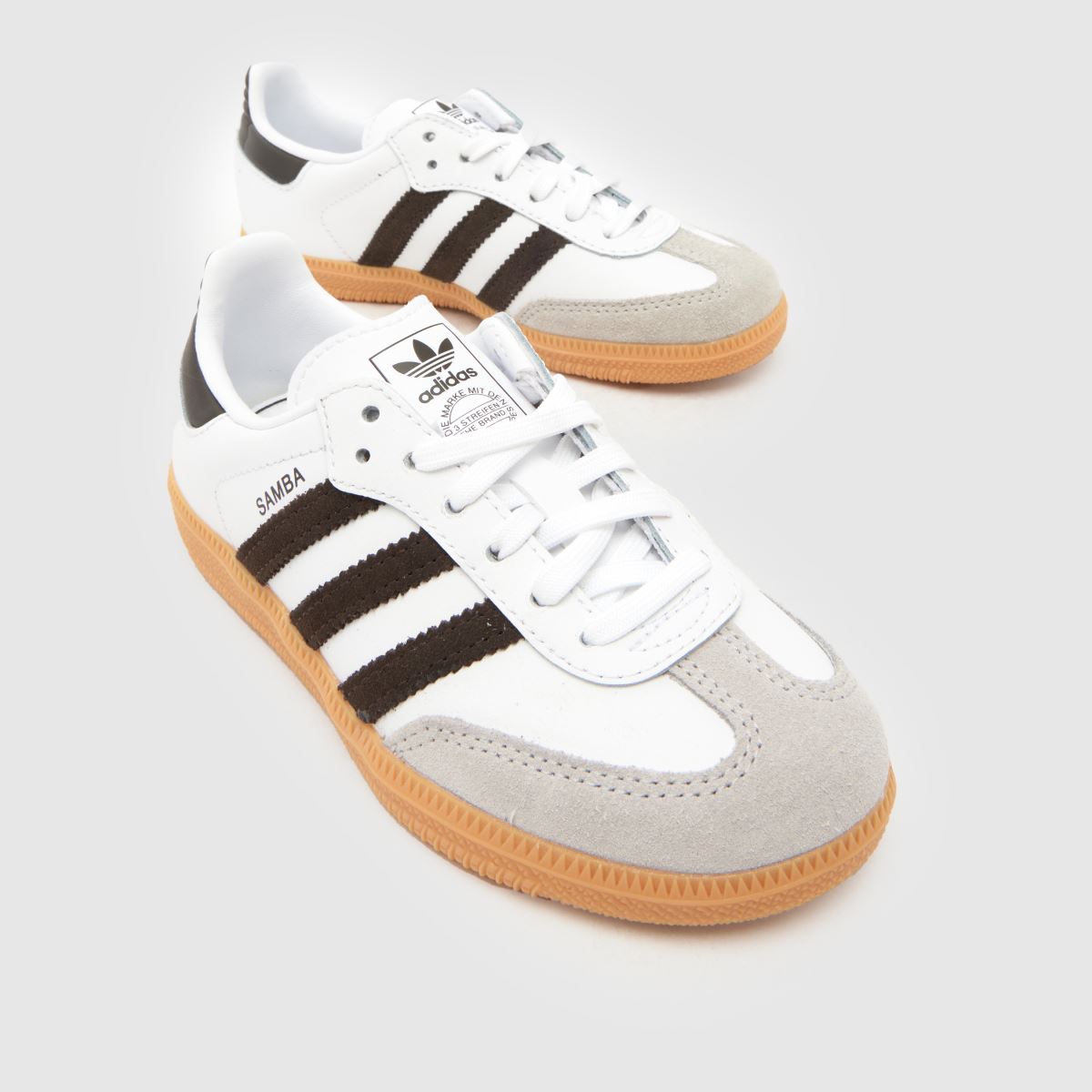 white adidas shoes with brown soles