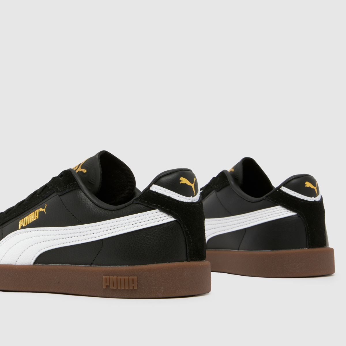 black white and gold pumas