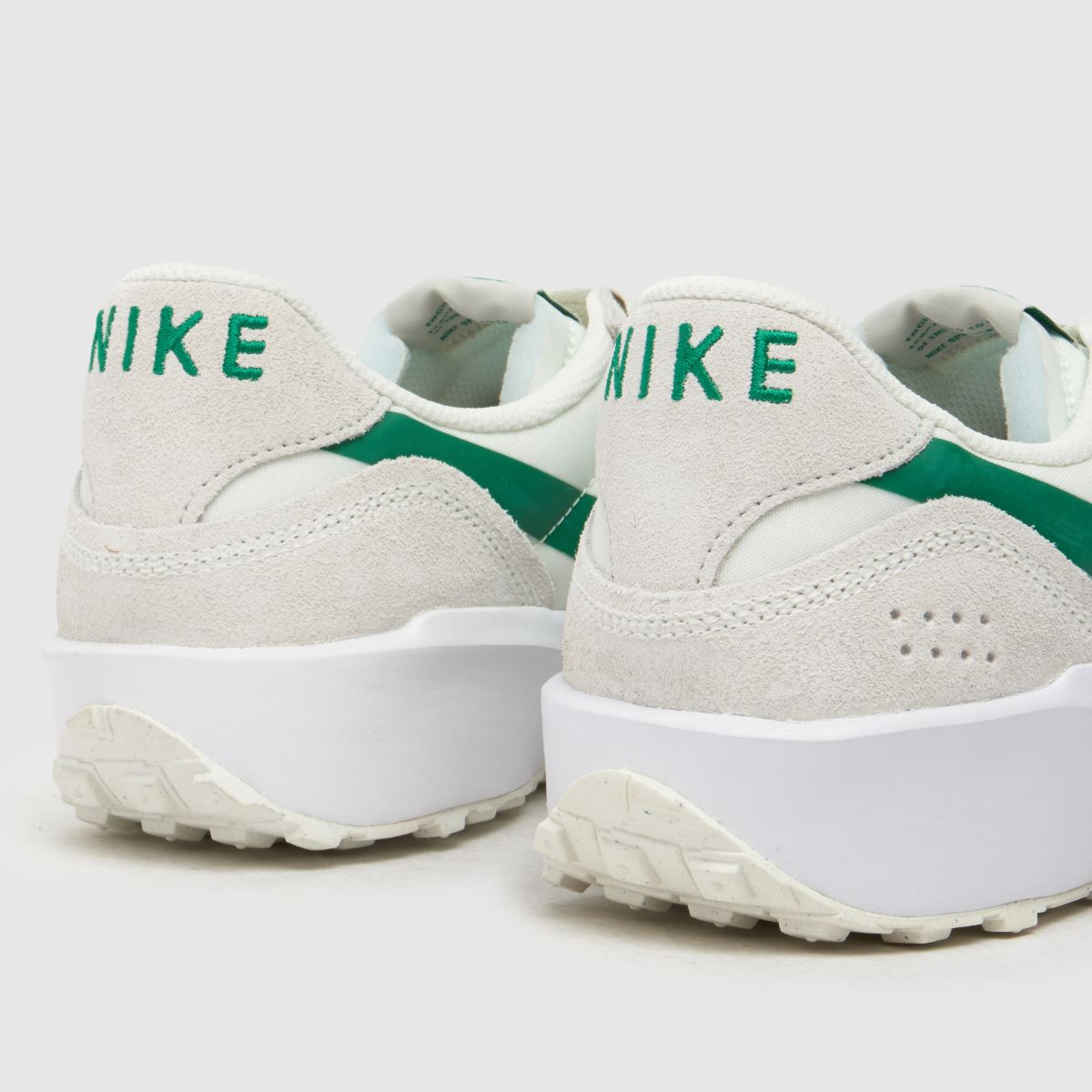 white nike trainers with green tick